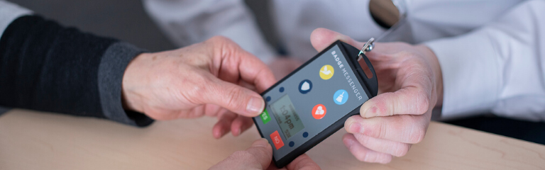 Person holding a Badge Messenger® device Person holding a Badge Messenger® device